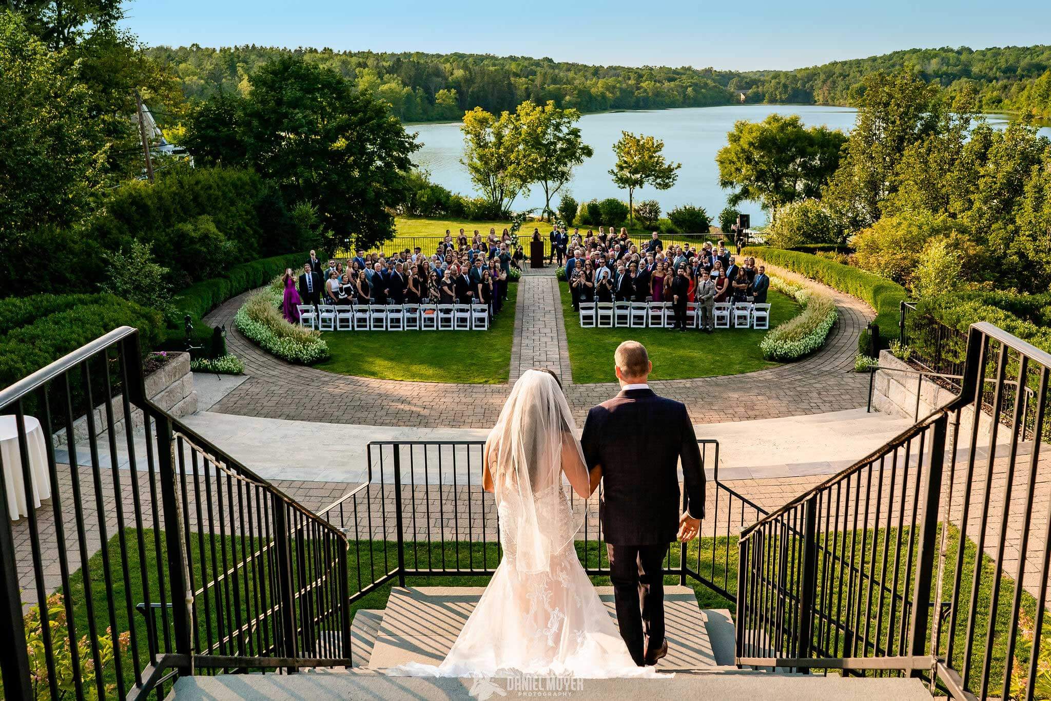 bride-walking-down-stairs-wedding-ceremony-at-lake-house-inn